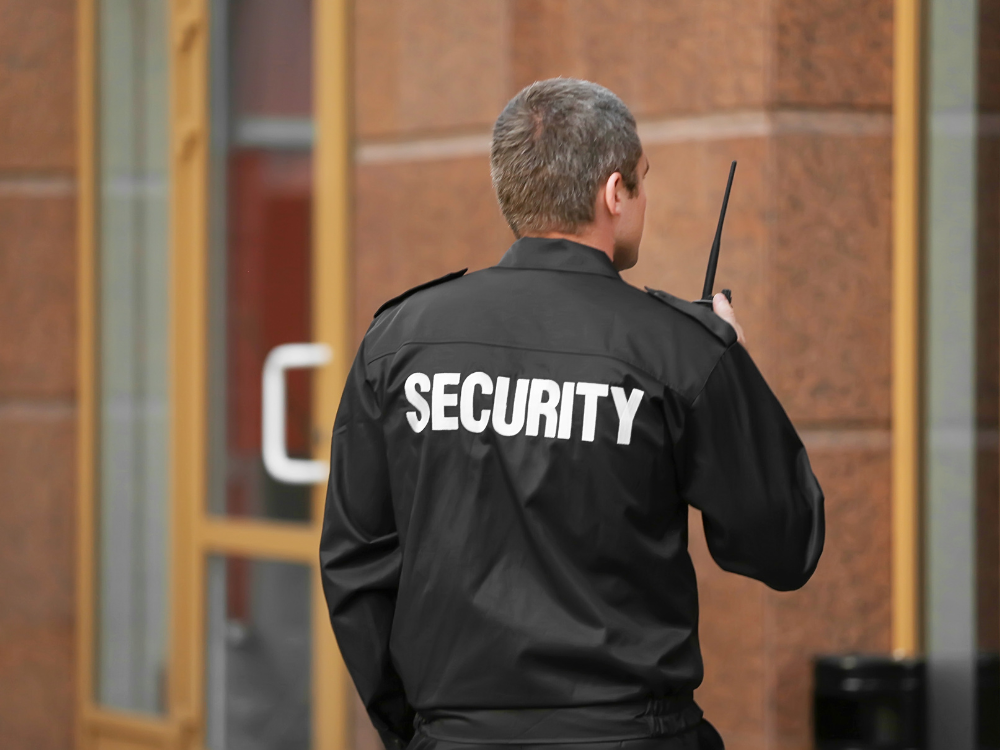 Security patrolling a building Security Guard patrolling the outside of a commercial property